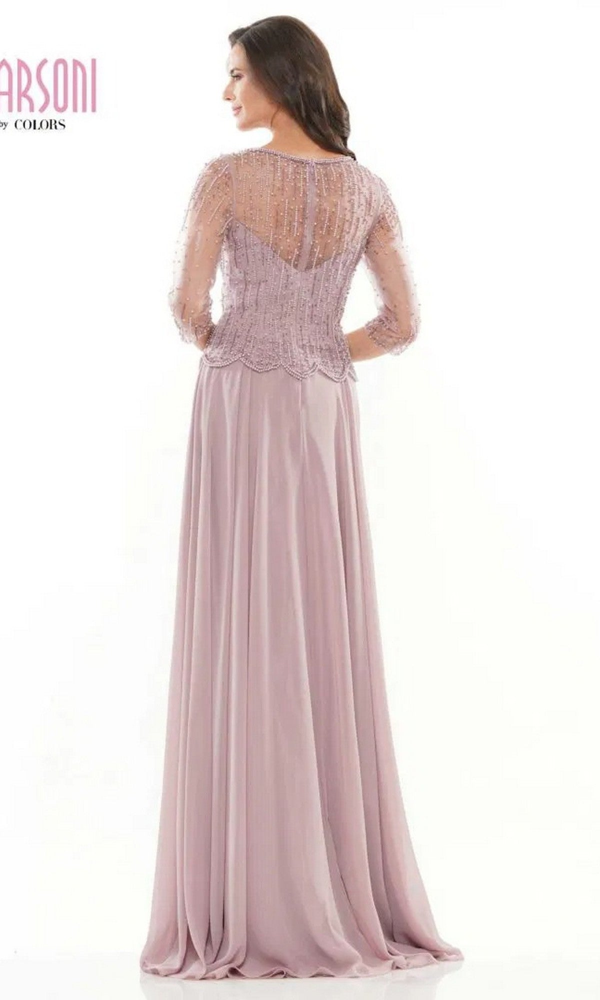 A woman faces away, wearing the Marsoni M312 long formal dress in light lavender, with sheer beaded sleeves and a beautifully beaded bodice that flows into an elegant A-line skirt.